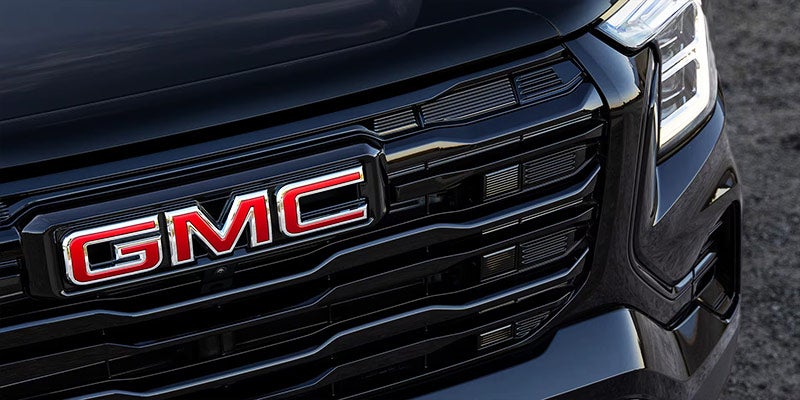 Close-up of the 2026 GMC Terrain signature GMC grille and bold front-end design in Le Mars, IA